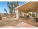 Inviting covered back patio featuring a picnic table and a dining table, perfect for outdoor entertaining at 3290 Vicki Ave, Las Vegas, NV 89139