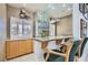 Custom bar area with mirrored wall, granite countertop, and seating creates a luxurious entertaining space at 3290 Vicki Ave, Las Vegas, NV 89139