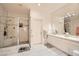 Bright bathroom featuring a glass-enclosed shower, vanity with quartz countertops, and tile floors at 3290 Vicki Ave, Las Vegas, NV 89139