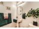Cozy bathroom features a pedestal sink, decorative mirror, and charming details at 3290 Vicki Ave, Las Vegas, NV 89139