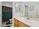 Bathroom with a single sink vanity, mirrored wall, and shower/tub combination at 3290 Vicki Ave, Las Vegas, NV 89139
