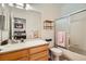 Bright bathroom with vanity and shower-tub combo, neutral color scheme and built in storage at 3290 Vicki Ave, Las Vegas, NV 89139