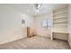 Bright bedroom features a built-in desk and shelving, neutral carpet, and a ceiling fan with a light at 3290 Vicki Ave, Las Vegas, NV 89139