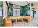 Unique breakfast nook with custom bench seating and tropical wallpaper provides a cozy dining space at 3290 Vicki Ave, Las Vegas, NV 89139