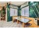 Corner breakfast nook with lots of natural light and tropical wallpaper for a refreshing start to your day at 3290 Vicki Ave, Las Vegas, NV 89139