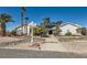 Charming single-story home with lush landscaping, mature palm trees, rock features, and a well-maintained walkway at 3290 Vicki Ave, Las Vegas, NV 89139