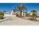Spacious single-story home featuring a wide driveway, a detached garage, and mature landscaping in a desert setting at 3290 Vicki Ave, Las Vegas, NV 89139