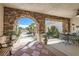 A charming front porch with decorative stone archway, tiled flooring and cozy seating area at 3290 Vicki Ave, Las Vegas, NV 89139