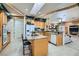 Modern kitchen featuring granite counters, an island with seating, and tile flooring at 3290 Vicki Ave, Las Vegas, NV 89139