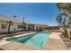 Inviting backyard featuring a private pool, mature palm trees, and a well-manicured lawn at 3290 Vicki Ave, Las Vegas, NV 89139