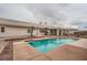An in-ground swimming pool with clear blue water is nestled in a backyard with palm trees at 3290 Vicki Ave, Las Vegas, NV 89139