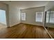 This bedroom features wood flooring, two large windows, and a closet at 3400 Cabana Dr # 1033, Las Vegas, NV 89122