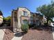 Exterior shot of a two-story condo unit with stairs and desert landscaping at 3400 Cabana Dr # 1033, Las Vegas, NV 89122