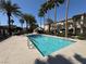 Community pool surrounded by palm trees and well-maintained landscaping at 3400 Cabana Dr # 1033, Las Vegas, NV 89122