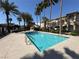 Sparkling community pool with clear blue water and lush palm tree landscaping at 3400 Cabana Dr # 1033, Las Vegas, NV 89122