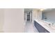 Bathroom featuring double sinks, modern fixtures and finishes, plus a walk-in closet at 353 E Bonneville Ave # 125, Las Vegas, NV 89101