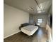 Minimalist bedroom featuring a comfortable bed, natural light, and workspace at 353 E Bonneville Ave # 125, Las Vegas, NV 89101