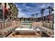 Luxurious pool area with comfortable seating, modern features, and mature palm trees at 353 E Bonneville Ave # 125, Las Vegas, NV 89101