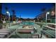 Inviting pool area with modern furniture, lush landscaping, and fire feature at 353 E Bonneville Ave # 125, Las Vegas, NV 89101