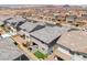 View of a house showcasing its backyard setup with patio, seating, and green space, surrounded by neighborhood residences at 356 Silva Pl, Henderson, NV 89011