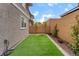 Backyard featuring artificial turf, rock features, and a well-maintained fence line at 356 Silva Pl, Henderson, NV 89011