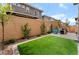 Spacious backyard features artificial turf, desert landscaping, and a seating area at 356 Silva Pl, Henderson, NV 89011