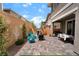 Inviting backyard featuring artificial turf, patio and seating area, and desert landscaping at 356 Silva Pl, Henderson, NV 89011