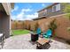 Charming backyard with artificial turf, a brick fence, and seating area at 356 Silva Pl, Henderson, NV 89011