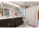 Bright bathroom with a double sink vanity, tiled floors, and shower-tub combination at 356 Silva Pl, Henderson, NV 89011