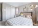 Bright bedroom features a plush bed, gold floor lamp, and a closet for ample storage at 356 Silva Pl, Henderson, NV 89011