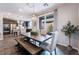 Bright dining area with modern chandelier, seamlessly flowing into the kitchen at 356 Silva Pl, Henderson, NV 89011