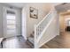 Bright entryway features wood-look flooring and a staircase with white railing at 356 Silva Pl, Henderson, NV 89011
