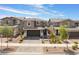Wide angle view of a two-story home with a paved driveway, attached garage, and attractive landscaping at 356 Silva Pl, Henderson, NV 89011