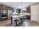 The spacious kitchen includes stainless appliances, dark cabinets, a center island and wood flooring at 356 Silva Pl, Henderson, NV 89011
