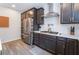 The kitchen features stainless steel appliances, dark cabinetry and white countertops at 356 Silva Pl, Henderson, NV 89011