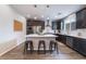 Modern kitchen features a center island with bar stool seating, stainless steel appliances, and dark wood cabinets at 356 Silva Pl, Henderson, NV 89011
