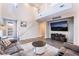 Comfortable seating area with wood floors, a staircase, and a large-screen television at 356 Silva Pl, Henderson, NV 89011