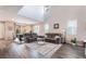 Bright living room featuring wood floors and vaulted ceilings, seamlessly flowing into the dining area at 356 Silva Pl, Henderson, NV 89011