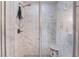 Walk-in shower featuring marble-look tiling, a glass enclosure, and modern showerhead at 356 Silva Pl, Henderson, NV 89011