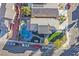 Aerial view of the home features a pool, green grass and privacy fenced yard at 3738 Falcon Springs Dr, Las Vegas, NV 89147