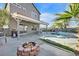 Backyard features a pool with spa, a fire pit and outdoor seating area with mature landscaping at 3738 Falcon Springs Dr, Las Vegas, NV 89147