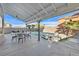 The backyard has a covered seating area and a pool with a spa in a fenced yard at 3738 Falcon Springs Dr, Las Vegas, NV 89147