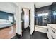 Jack and Jill bathroom with marble countertops, black accents, and shower/tub combo adjacent to a guest bedroom at 3738 Falcon Springs Dr, Las Vegas, NV 89147
