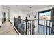 Upstairs hallway features modern railings, hardwood floors, and an open view of the downstairs living area at 3738 Falcon Springs Dr, Las Vegas, NV 89147