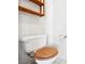 Close up of a toilet in a half bathroom with a wood-look toilet seat at 3854 Spruceview Ct, Las Vegas, NV 89147