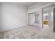 A bright bedroom features neutral carpet, a mirrored closet, and adjacent bathroom access at 3854 Spruceview Ct, Las Vegas, NV 89147