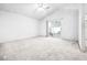 Spacious bedroom featuring neutral carpet, ample natural light, and an attached bathroom at 3854 Spruceview Ct, Las Vegas, NV 89147