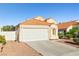 Attached two-car garage and tidy landscaping with a classic red tile roof at 3854 Spruceview Ct, Las Vegas, NV 89147
