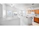 Bright kitchen with wooden cabinets, bar top, tile floors, breakfast nook and lots of natural light at 3854 Spruceview Ct, Las Vegas, NV 89147