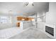 Open-concept living space featuring the kitchen and fireplace, with neutral tones and tile flooring at 3854 Spruceview Ct, Las Vegas, NV 89147
